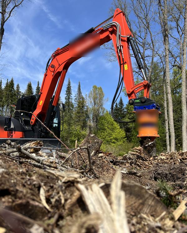 Example photo: a machine with a grinding head on cleared ground