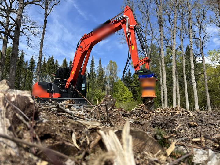 Example photo: a machine with a grinding head on cleared ground