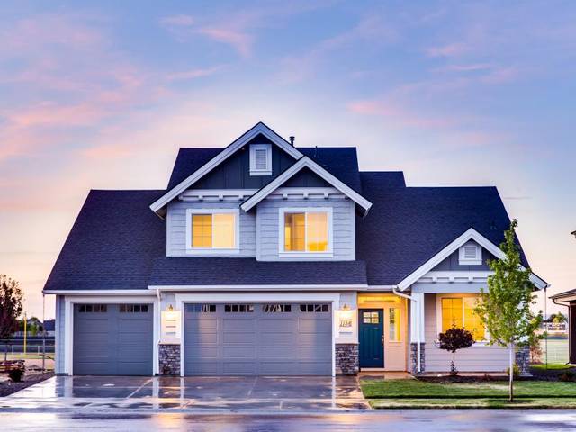 A house at dusk with a trimmed lawn